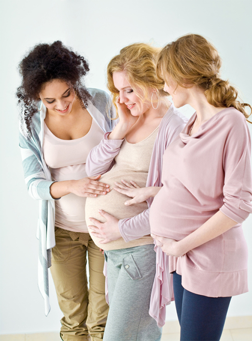 People gathering round a pregnant person