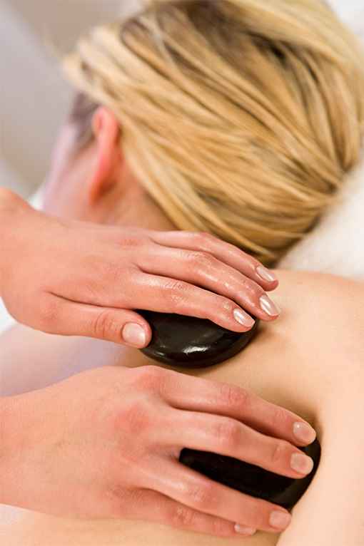 Person receiving hot stone massage