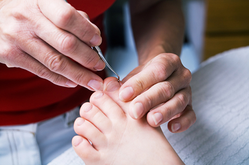 Person receiving nail treatment